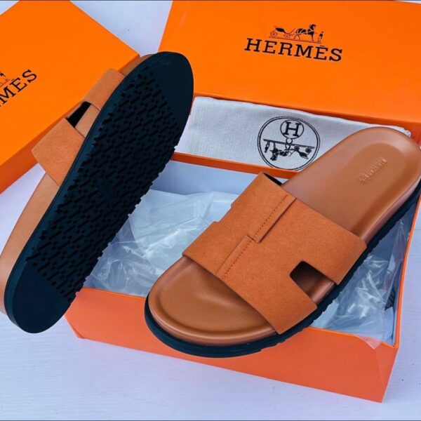 These Hermes brown and black H cut out strap slide sandals combine timeless elegance with contemporary luxury. Featuring the iconic H inspired strap design and a refined silhouette these sandals offer a sophisticated look for modern casual styling.