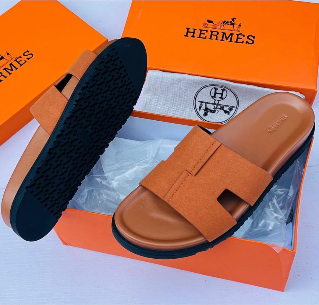 These Hermes brown and black H cut out strap slide sandals combine timeless elegance with contemporary luxury. Featuring the iconic H inspired strap design and a refined silhouette these sandals offer a sophisticated look for modern casual styling.
