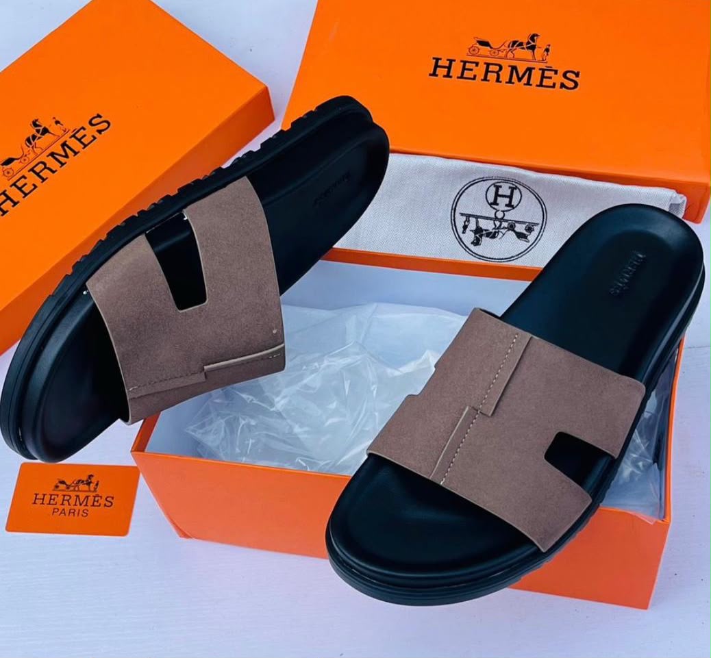 These Hermes brown and black H cut out strap slide sandals combine timeless elegance with contemporary luxury. Featuring the iconic H inspired strap design and a refined silhouette these sandals offer a sophisticated look for modern casual styling.